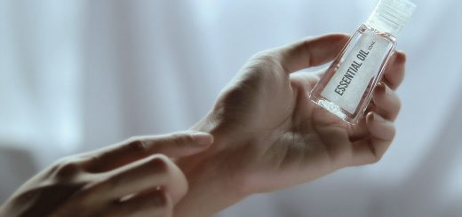 Adult applying essential oil to wrist