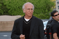 older man in a black outfit unsure what to do