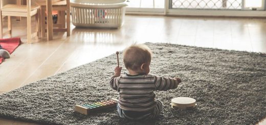 baby playing instruments on the floor