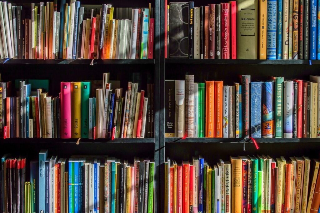 three rows of book shelves packed with books and resources