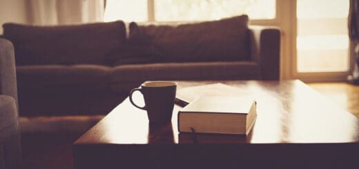 living room area, view zoomed in on maroon couch and coffee table