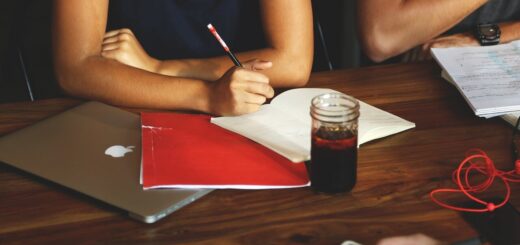 woman in black shirt taking notes